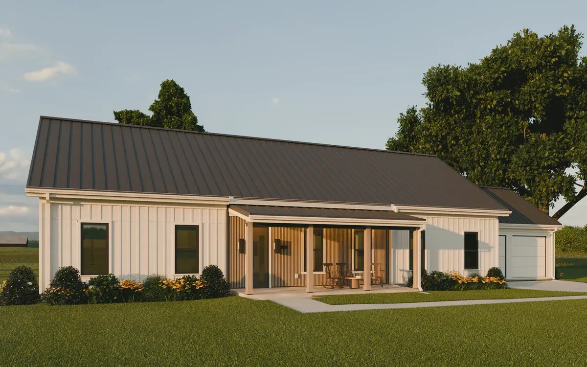 The front of the house at golden hour: two white wings, the cedar-clad porch between them with its lights on, and the garage stepped back on the right. The Stones, a one-story dogtrot farmhouse house plan by House of KNA.