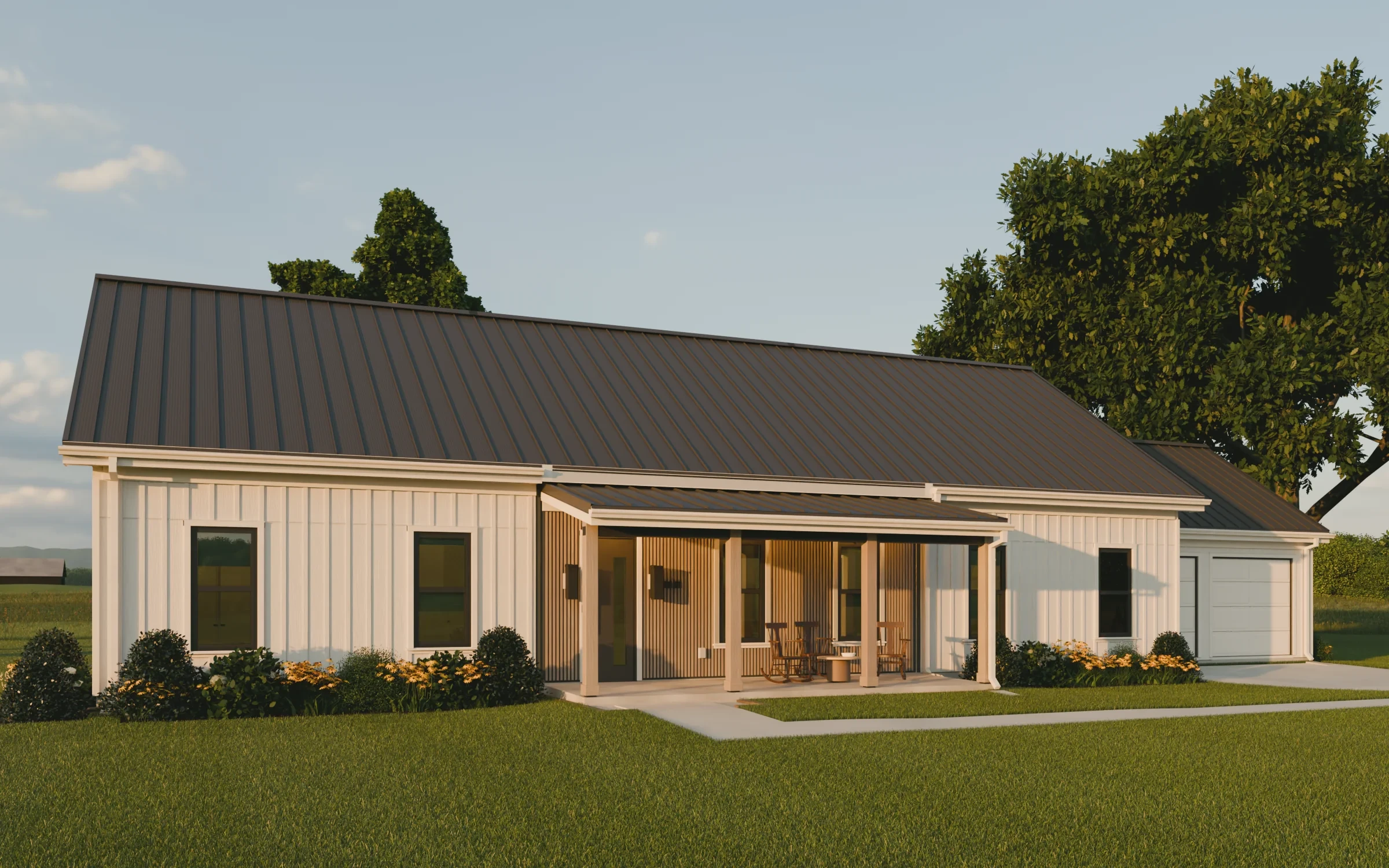 The front of the house at golden hour: two white wings, the cedar-clad porch between them with its lights on, and the garage stepped back on the right. The Stones, a one-story dogtrot farmhouse house plan by House of KNA.